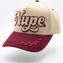 Load image into Gallery viewer, Beige and red cap with 'Nupe' logo on a white background