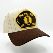 Load image into Gallery viewer, Cap with a yellow and black patch featuring 'Iota Phi Theta' on a white background