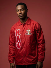Load image into Gallery viewer, Man wearing a red jacket with 'KAY' logo on a red background