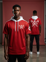 Load image into Gallery viewer, Person wearing a red hoodie with white designs, standing in front of a red background.