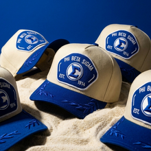 Load image into Gallery viewer, Collection of Phi Beta Sigma hats with blue and beige design on a blue background