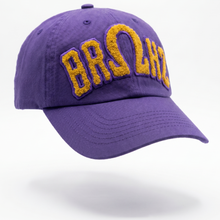 Load image into Gallery viewer, Purple cap with yellow text on a white background
