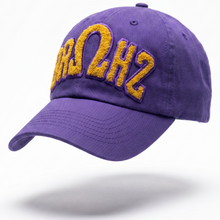 Load image into Gallery viewer, Purple cap with yellow text on a white background
