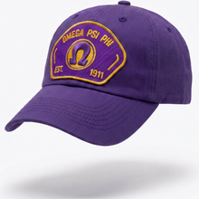 Load image into Gallery viewer, Purple cap with Omega Psi Phi logo on a white background
