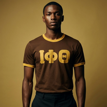 Load image into Gallery viewer, Man wearing a brown shirt with gold lettering against a beige background
