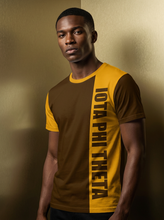 Load image into Gallery viewer, Man wearing a brown and yellow t-shirt with 'Iota Phi Theta' text against a gold background
