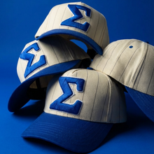 Load image into Gallery viewer, Three baseball caps with blue and gray design on a blue background

